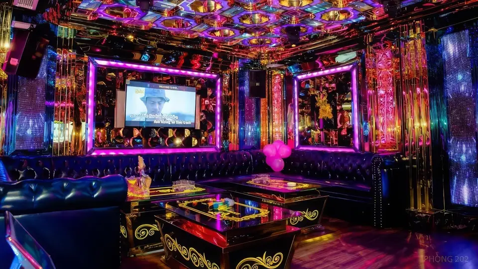 Avatar Karaoke VIP party room 202 featuring pink LED-framed screen, gold mirror panels, and black leather sofas