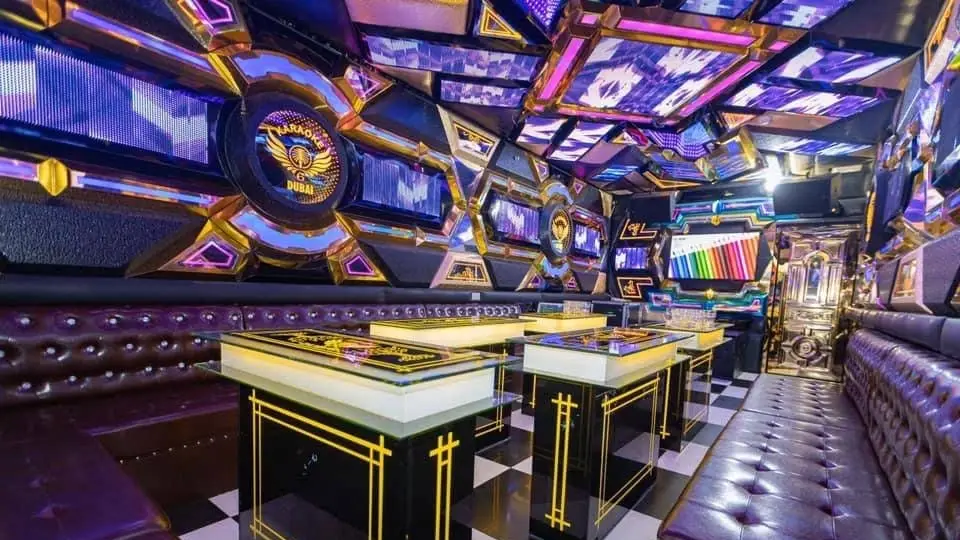 Dubai private room with gold-framed hexagon mirror walls, Karaoke 6 logo, and black-and-gold checkered flooring